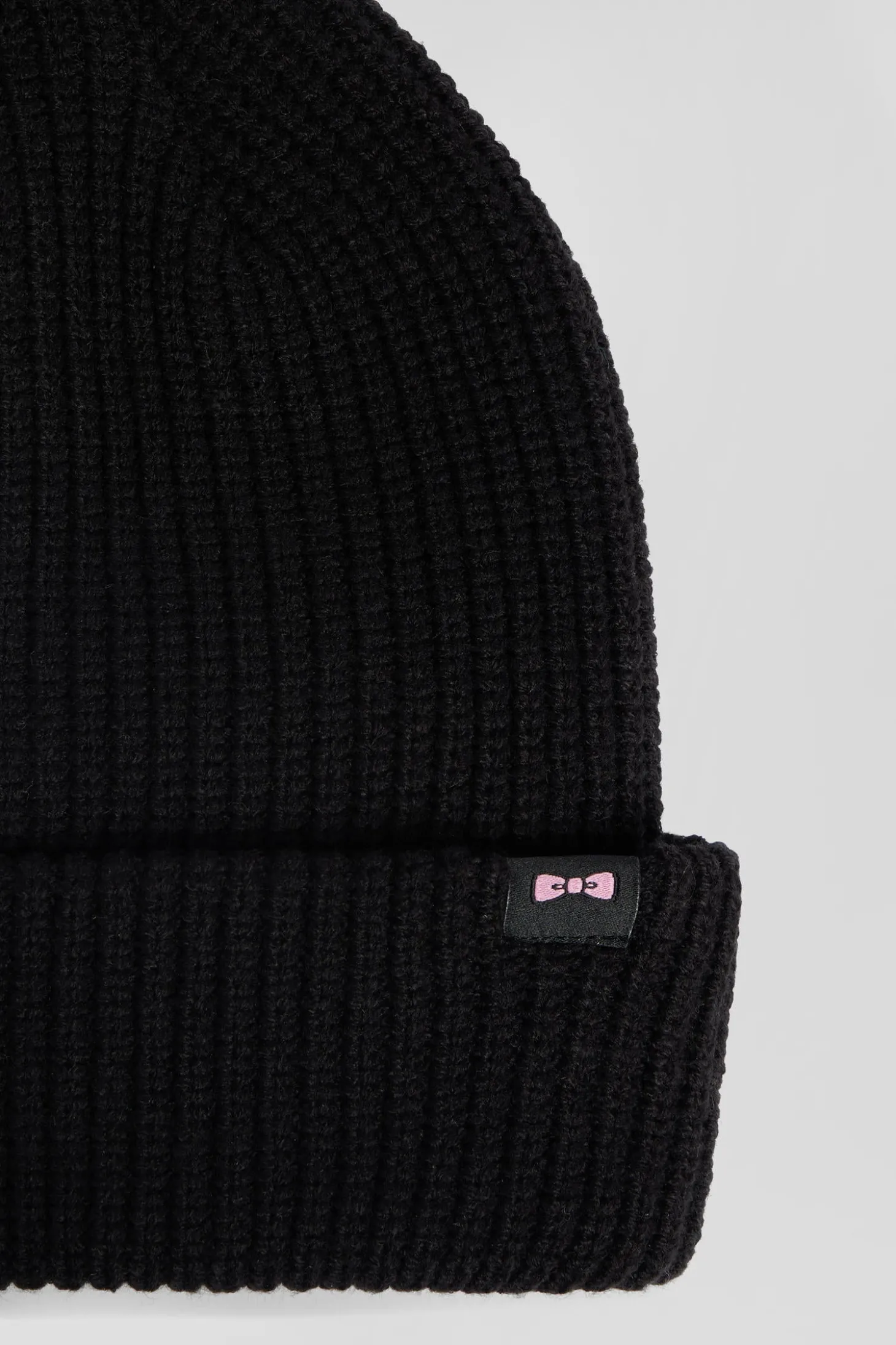 Black knitted beanie with bow tie embroidery