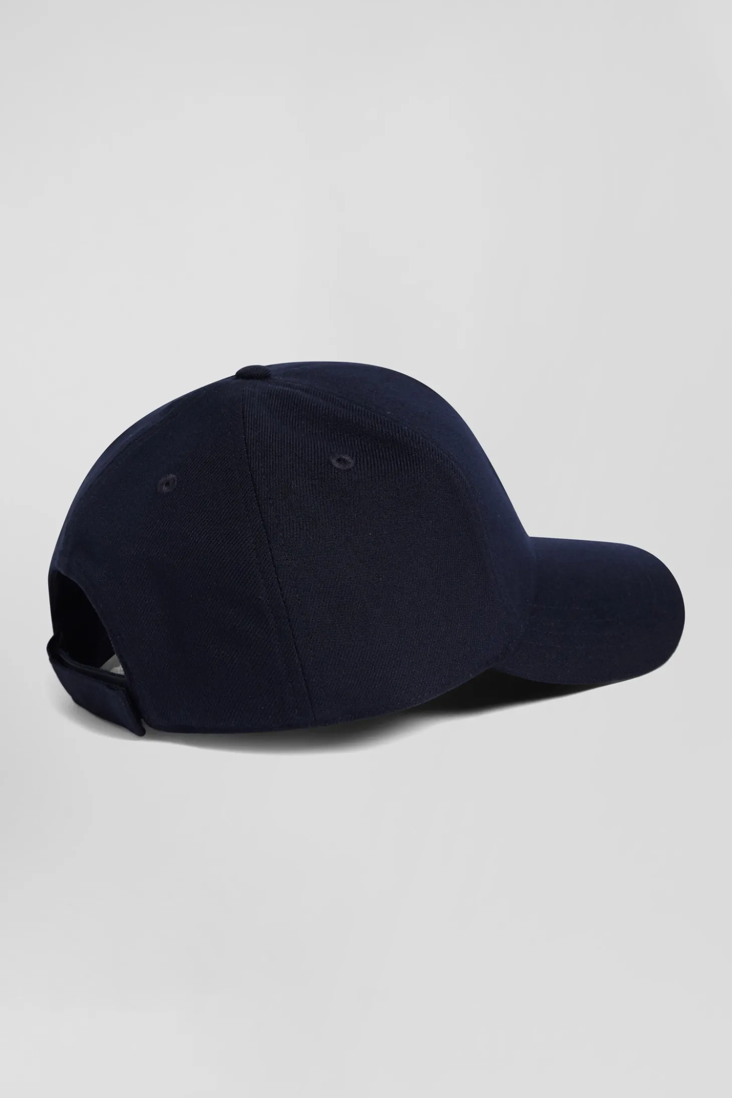 Navy blue cap with bow tie emblem