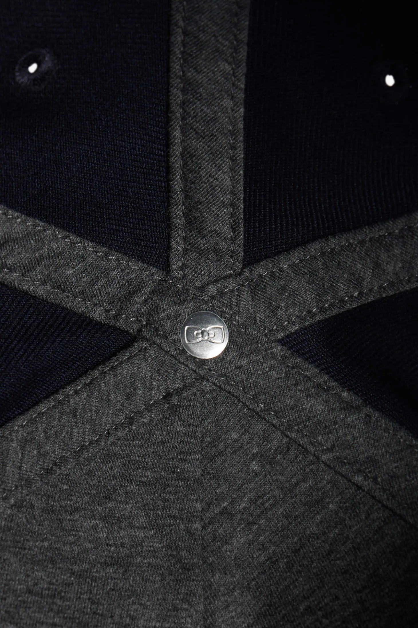Navy blue cap with bow tie emblem