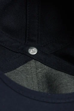 Navy blue cap with rubber badge and tricolour trim