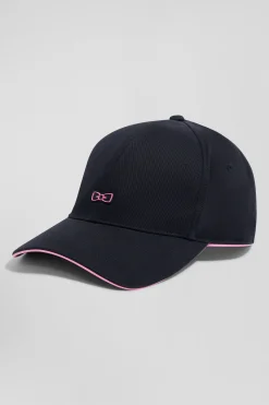 Navy blue cotton cap with bow tie badge and pink piping