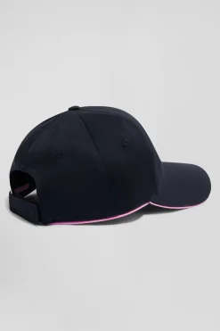 Navy blue cotton cap with bow tie badge and pink piping