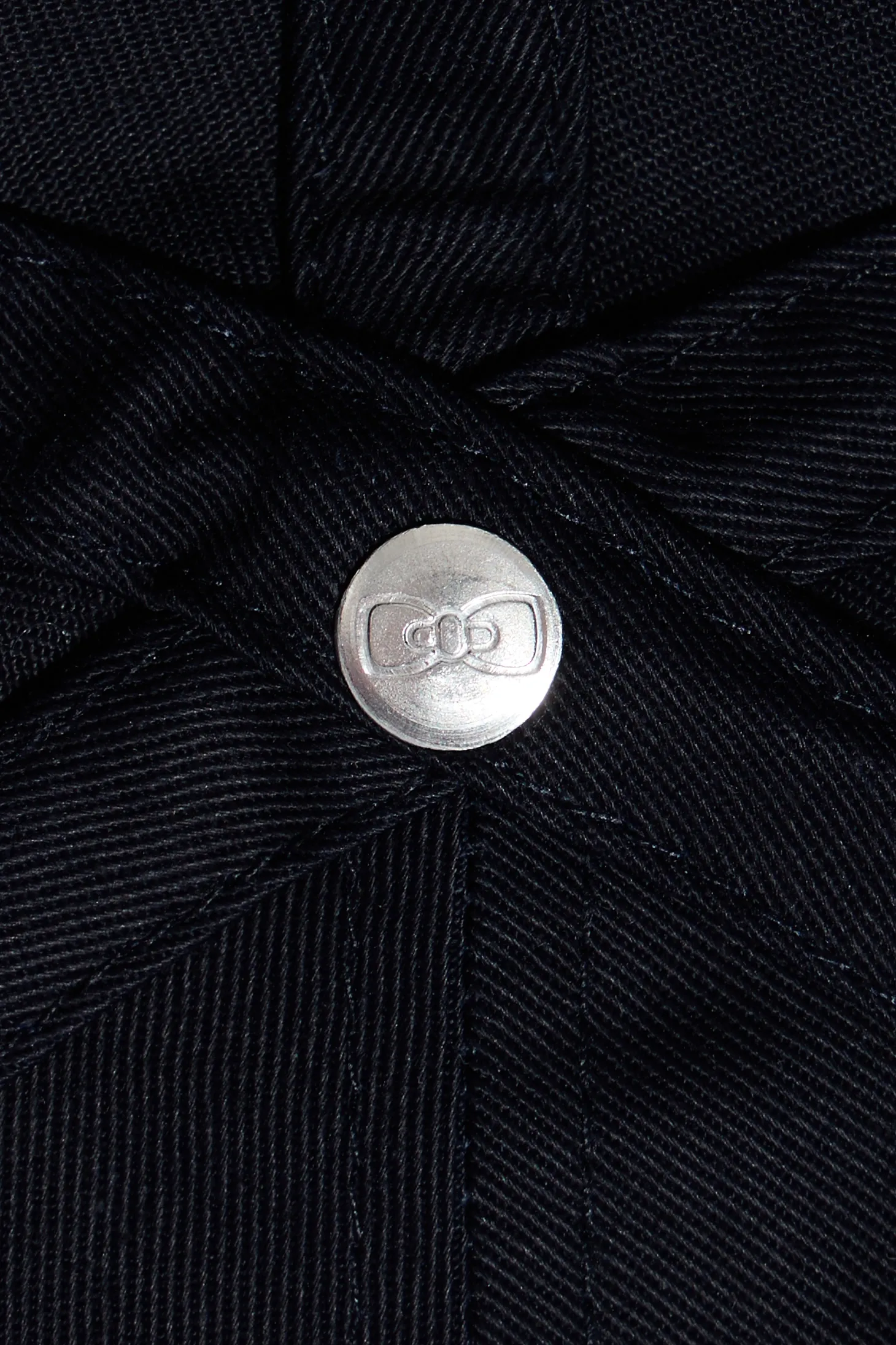 Navy blue cotton cap with bow tie badge and pink piping