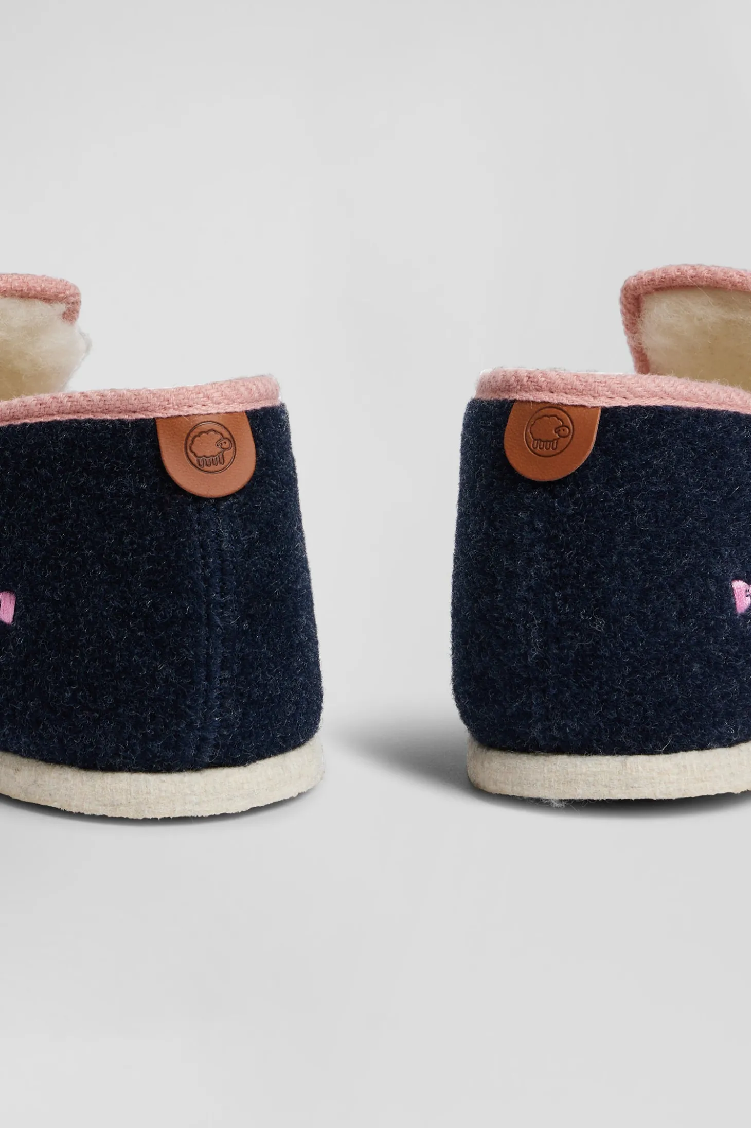 Navy blue shearling slippers with pink trim