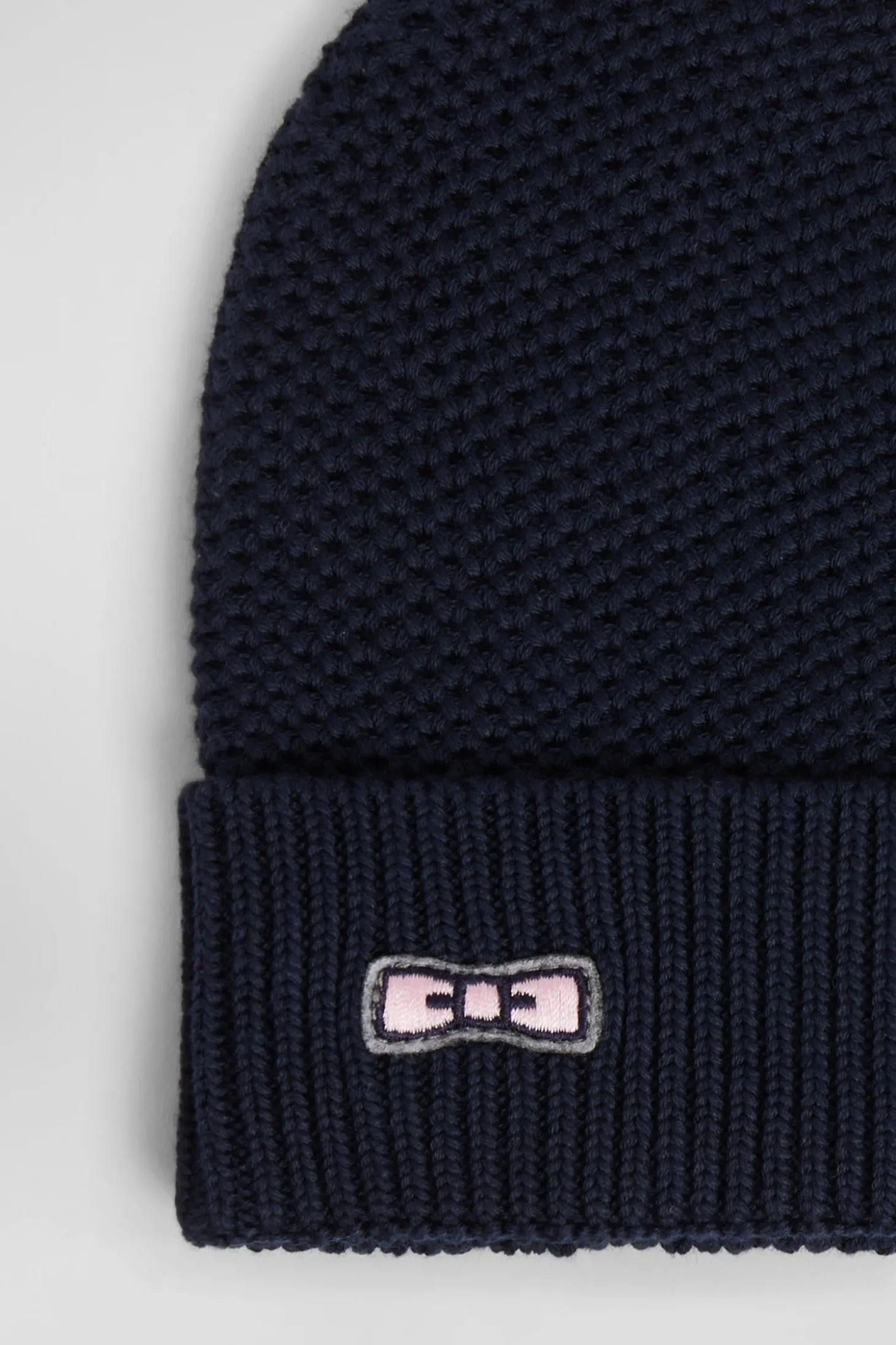 Plain navy blue cotton beanie with bow tie embroidery