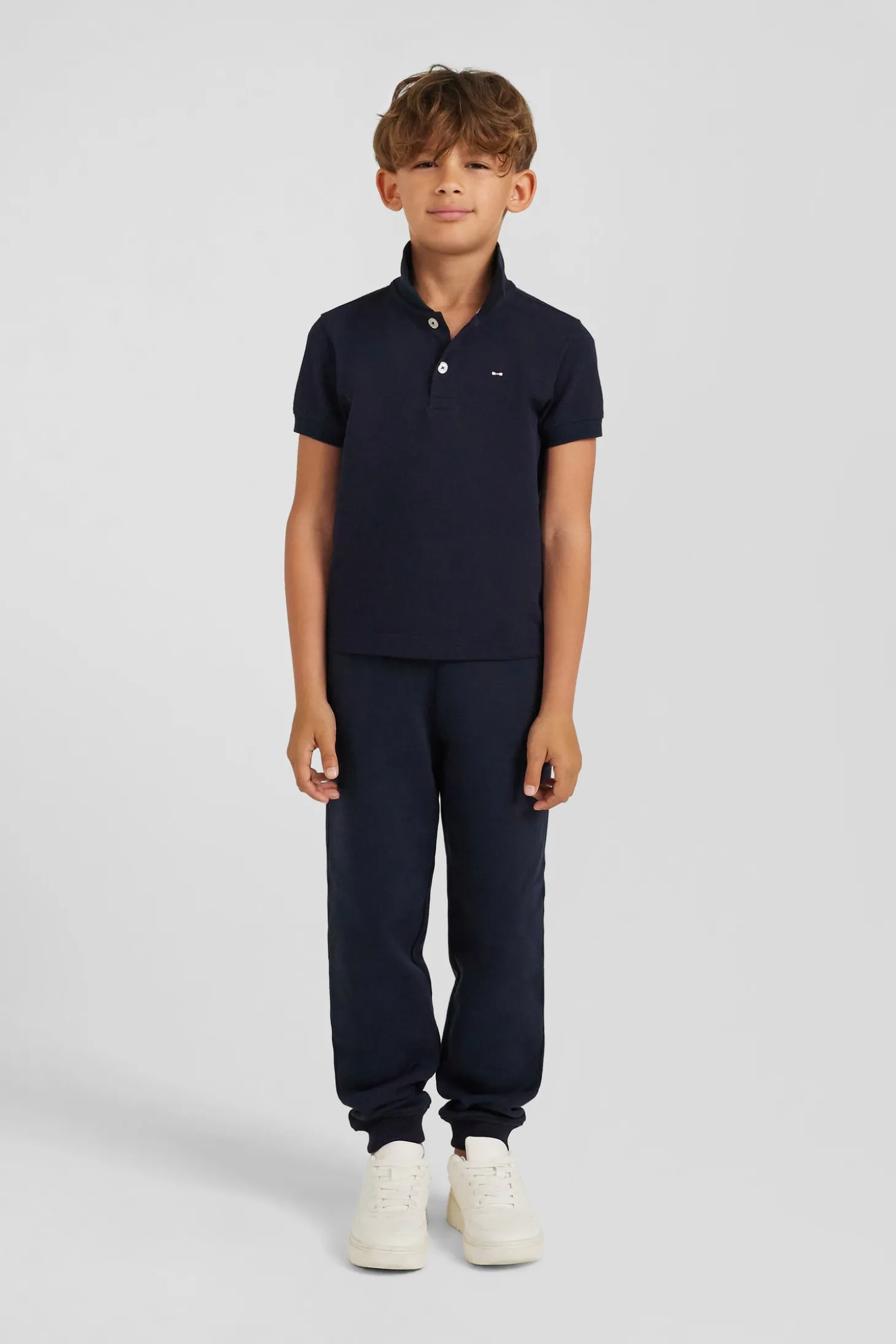 Regular navy blue short-sleeved cotton piqué polo shirt with back bow tie embroidery