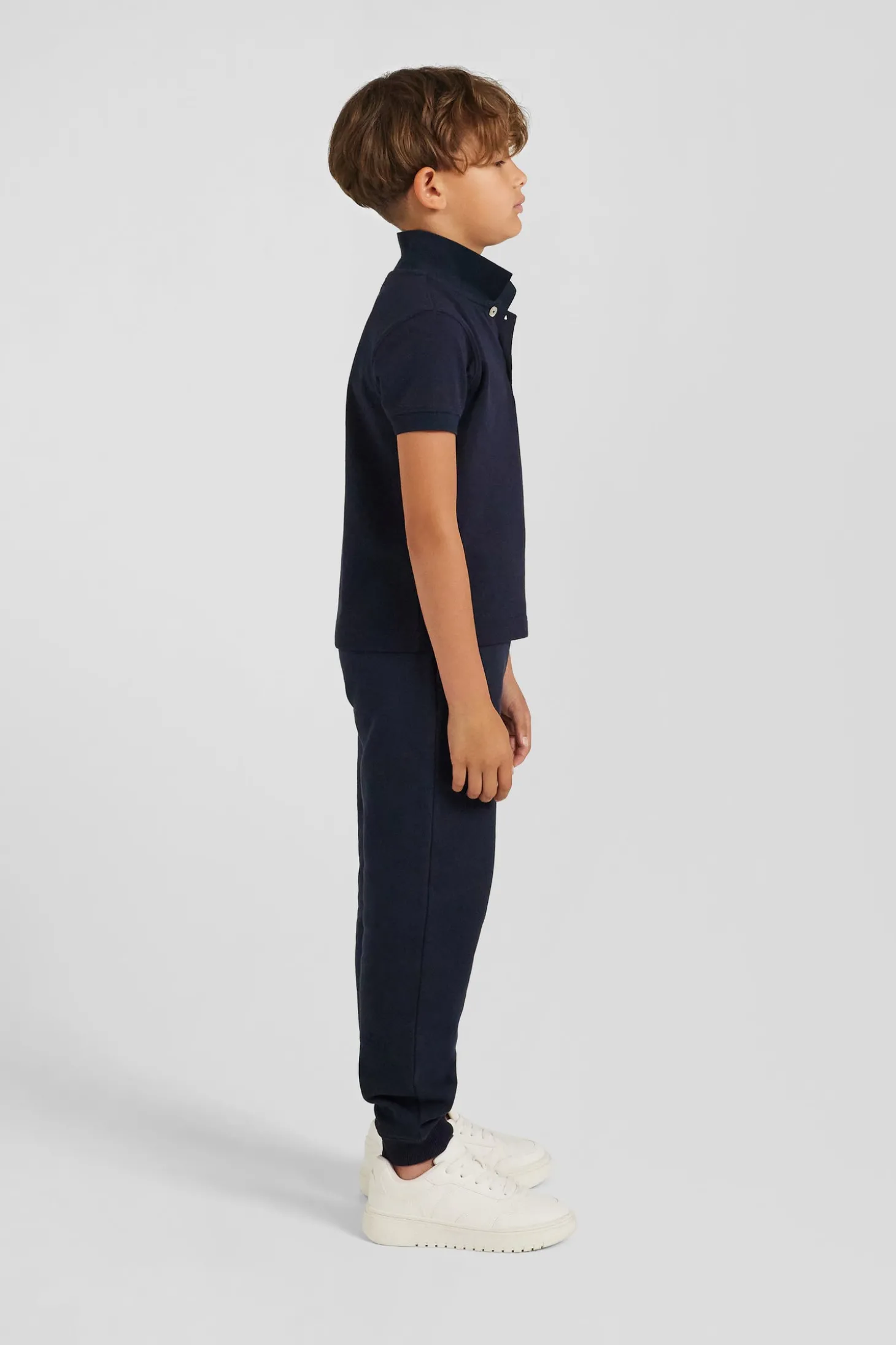 Regular navy blue short-sleeved cotton piqué polo shirt with back bow tie embroidery