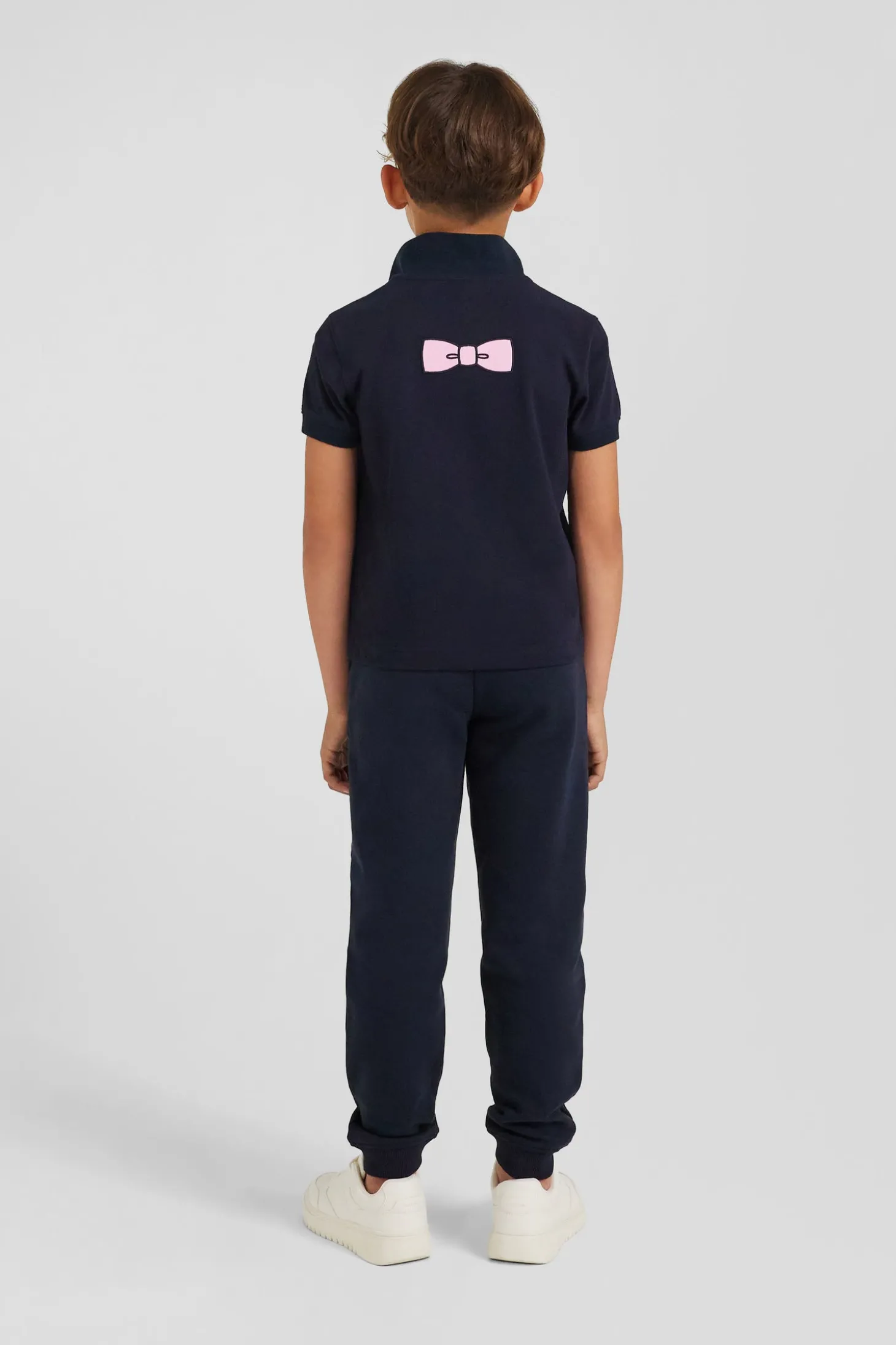 Regular navy blue short-sleeved cotton piqué polo shirt with back bow tie embroidery