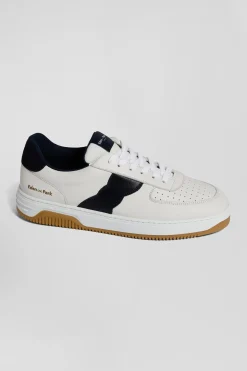 White low-top leather sneakers with navy blue cut-out