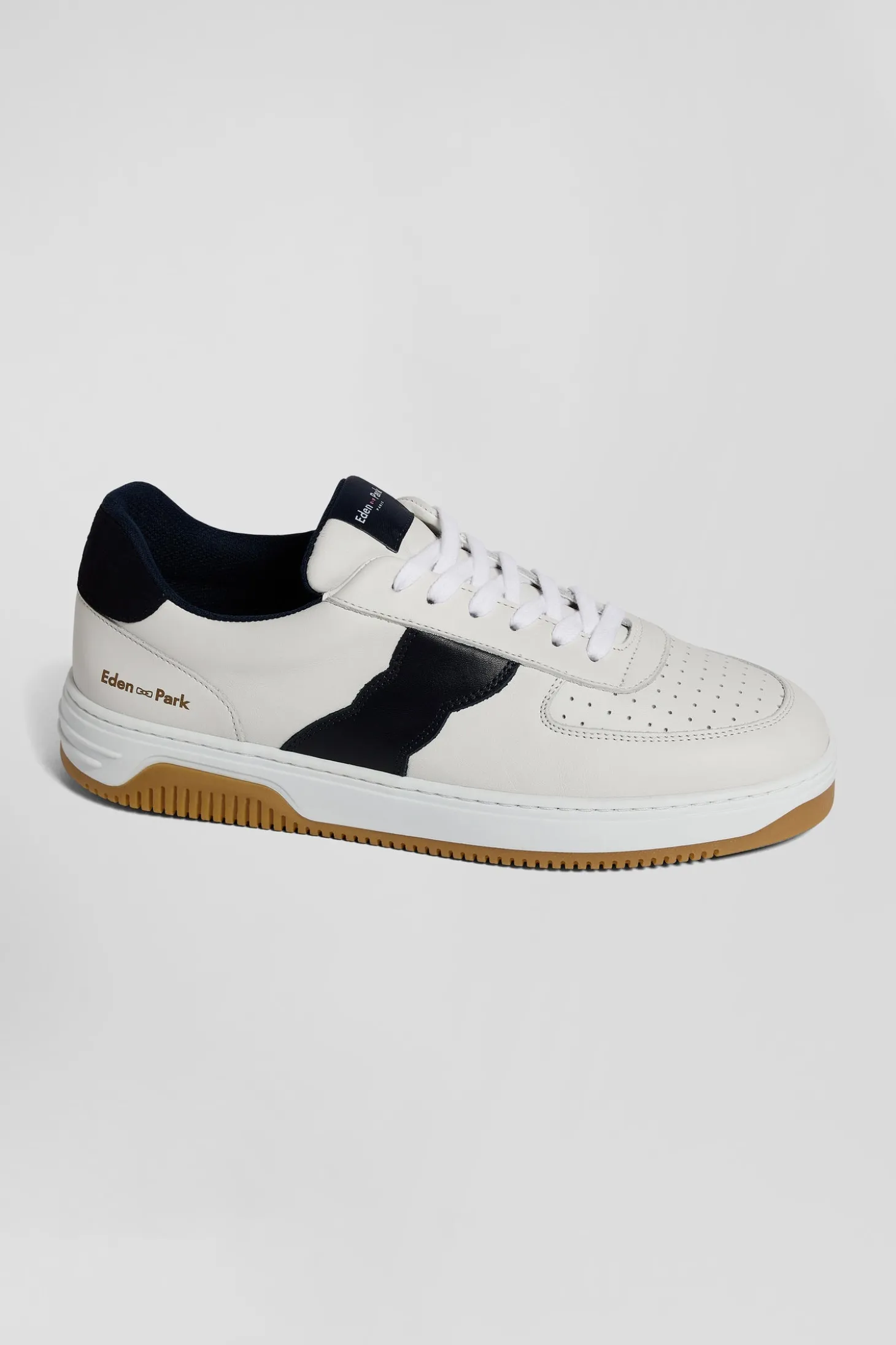 White low-top leather sneakers with navy blue cut-out