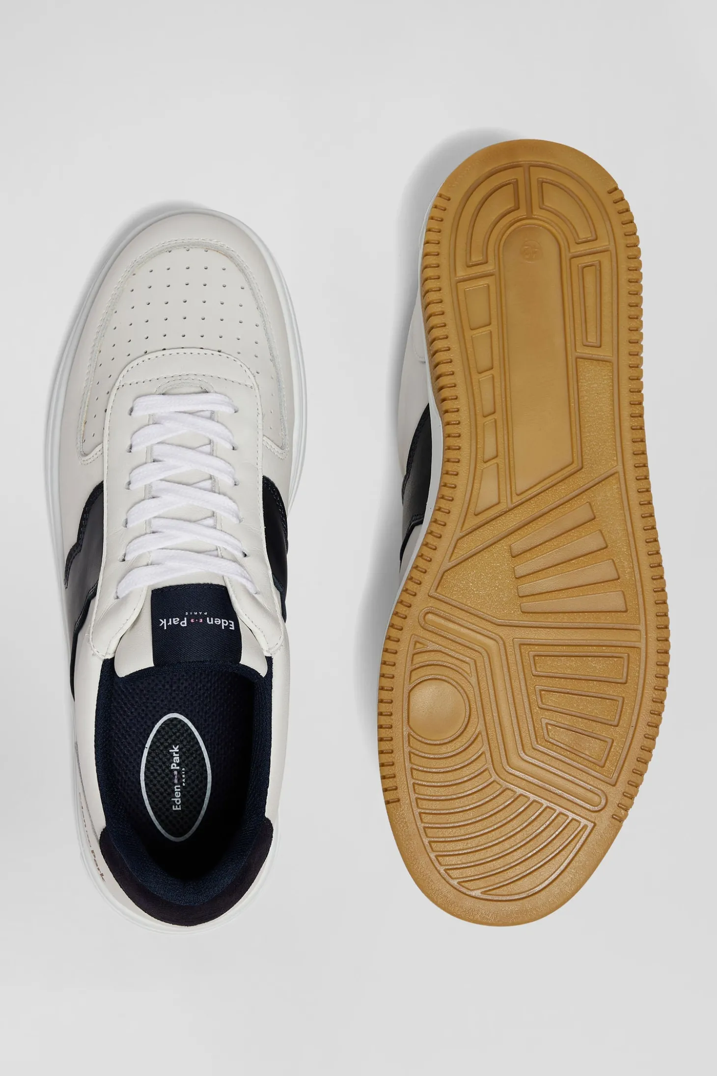 White low-top leather sneakers with navy blue cut-out